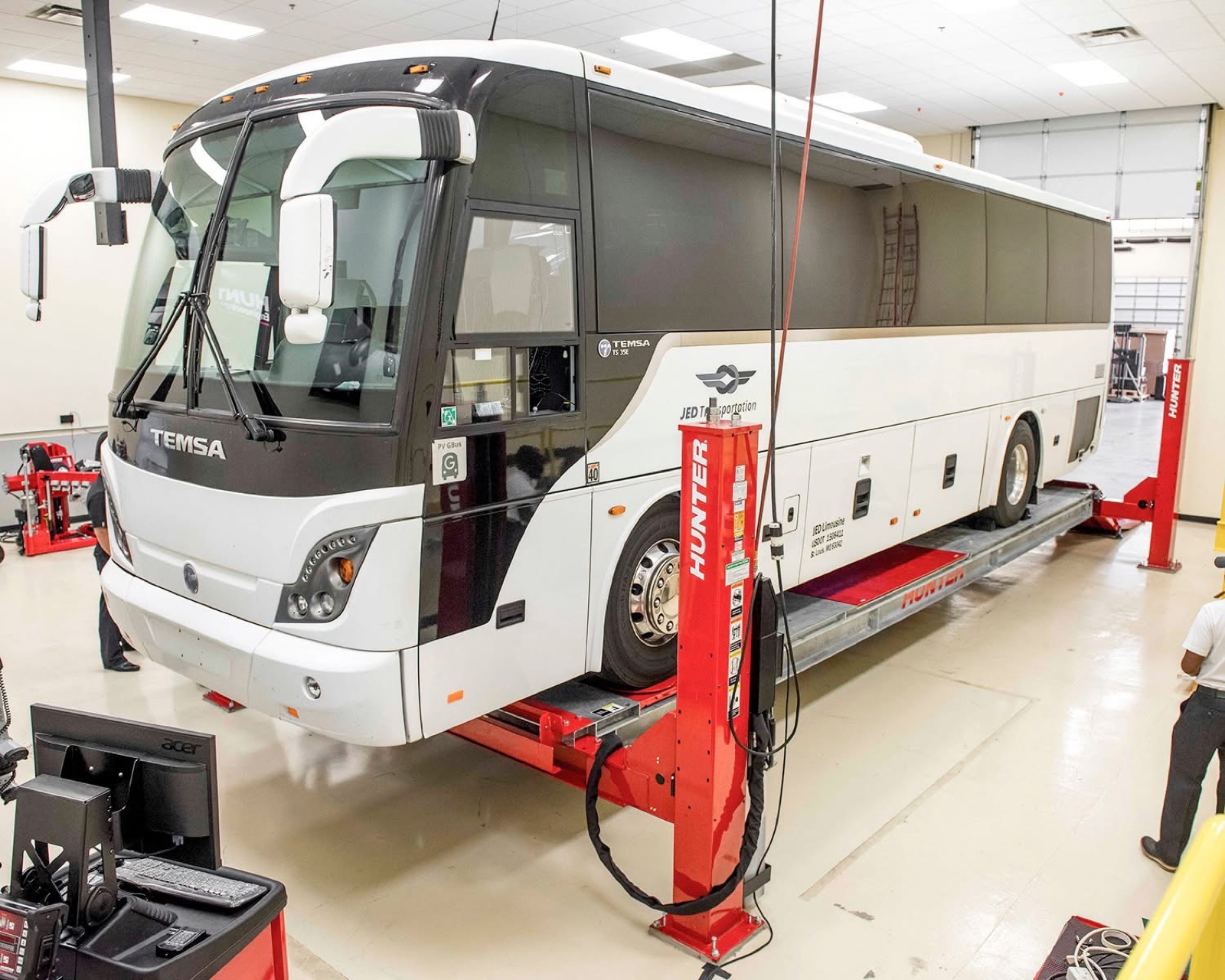 Transit coach on a Hunter HD drive-thru alignment rack